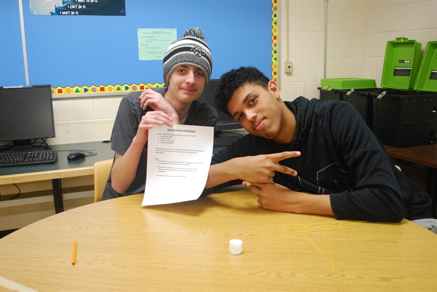 picture of students holding a piece of paper up