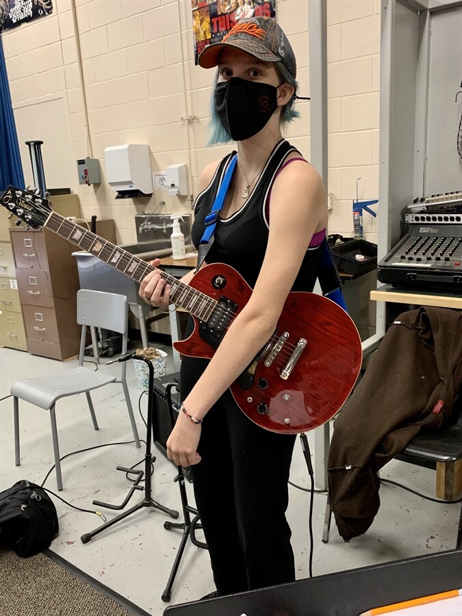 Picture of a student playing guitar