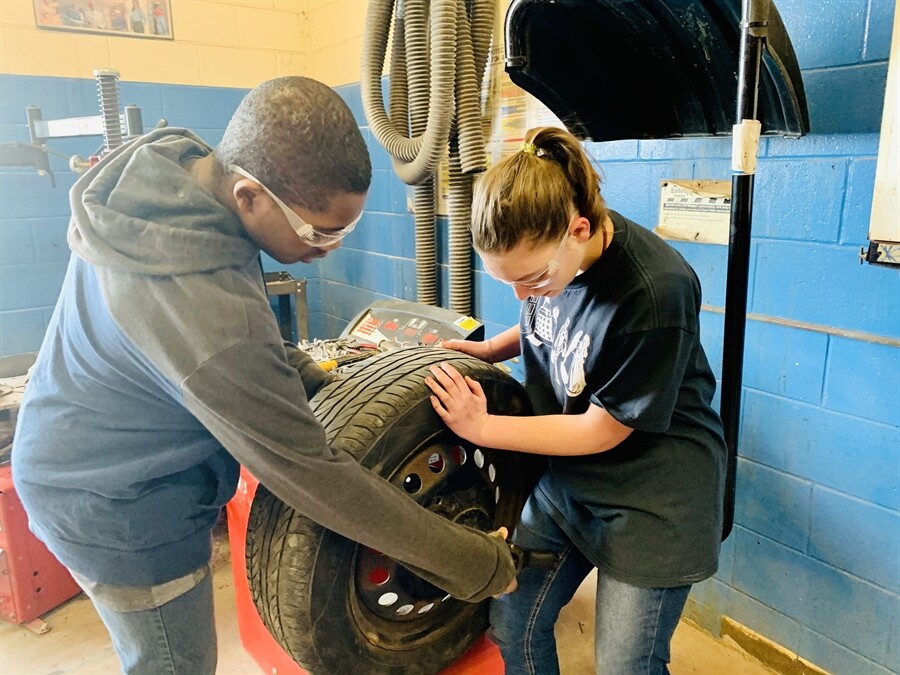 Picture of a student using a tire balancing machine