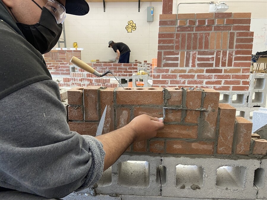 picture of students building a brick walll