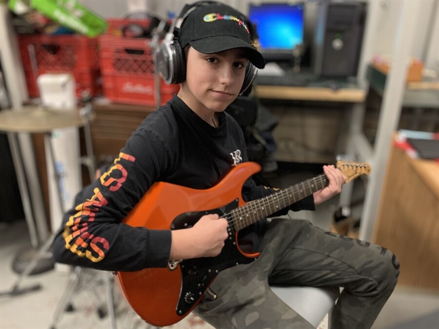 Picture of a student playing guitar