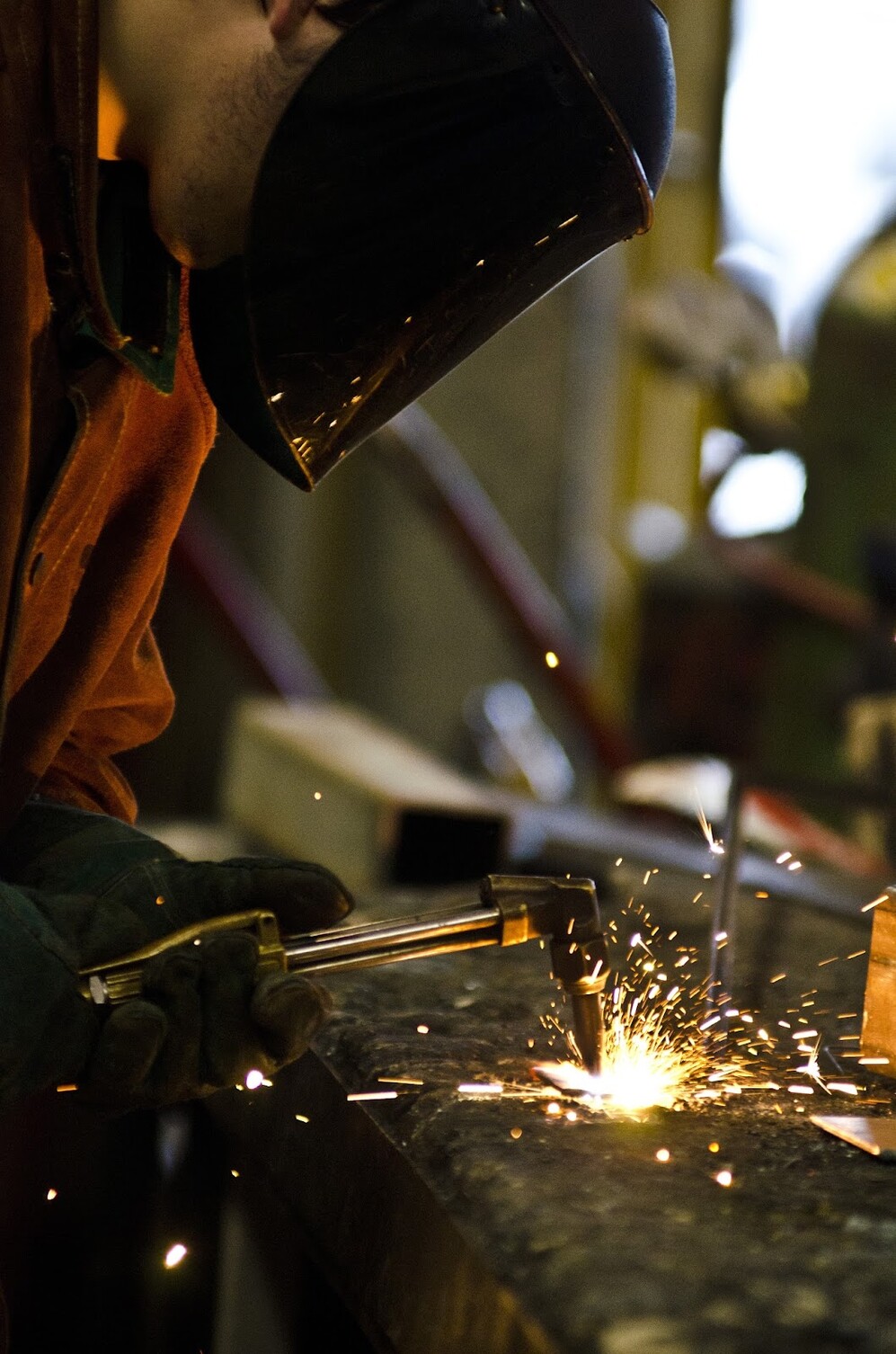 Picture of a student welding a piece of metal